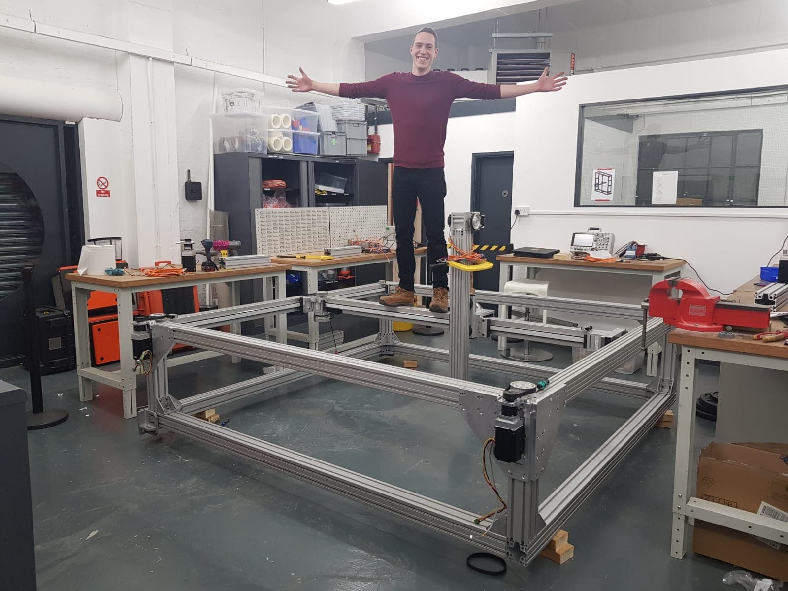 Joshua Kiff standing on the 5-axis gantry during assembly