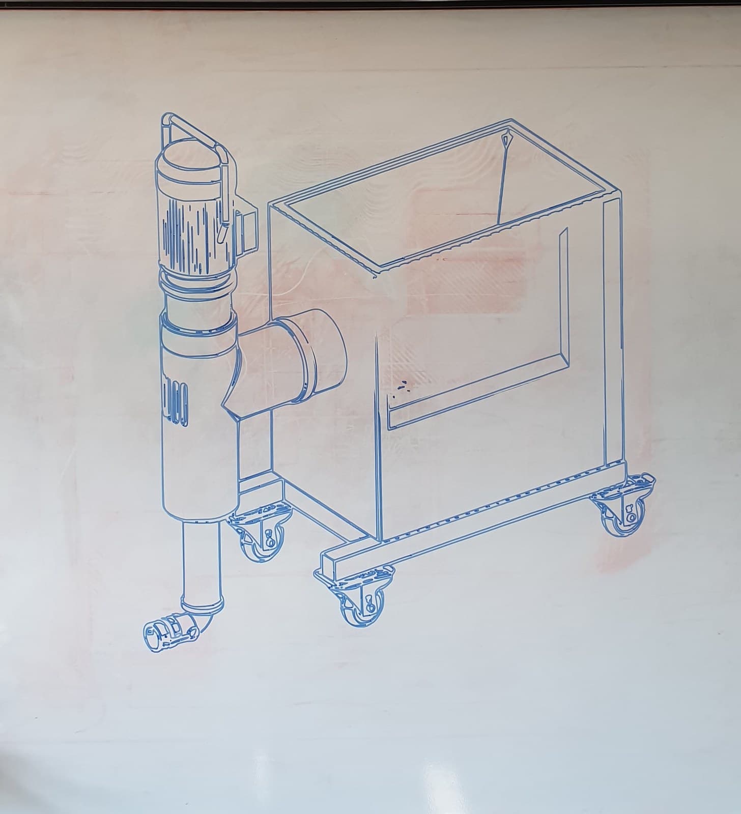 CAD-style isometric sketch of a machine drawn on the whiteboard
