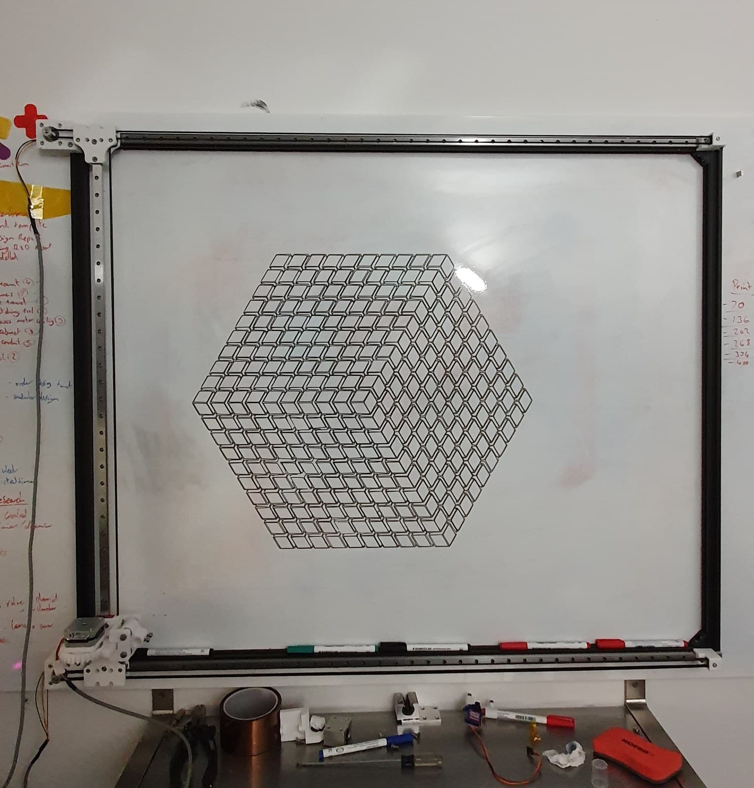 The plotter mounted on the wall with a finished hexagon pattern