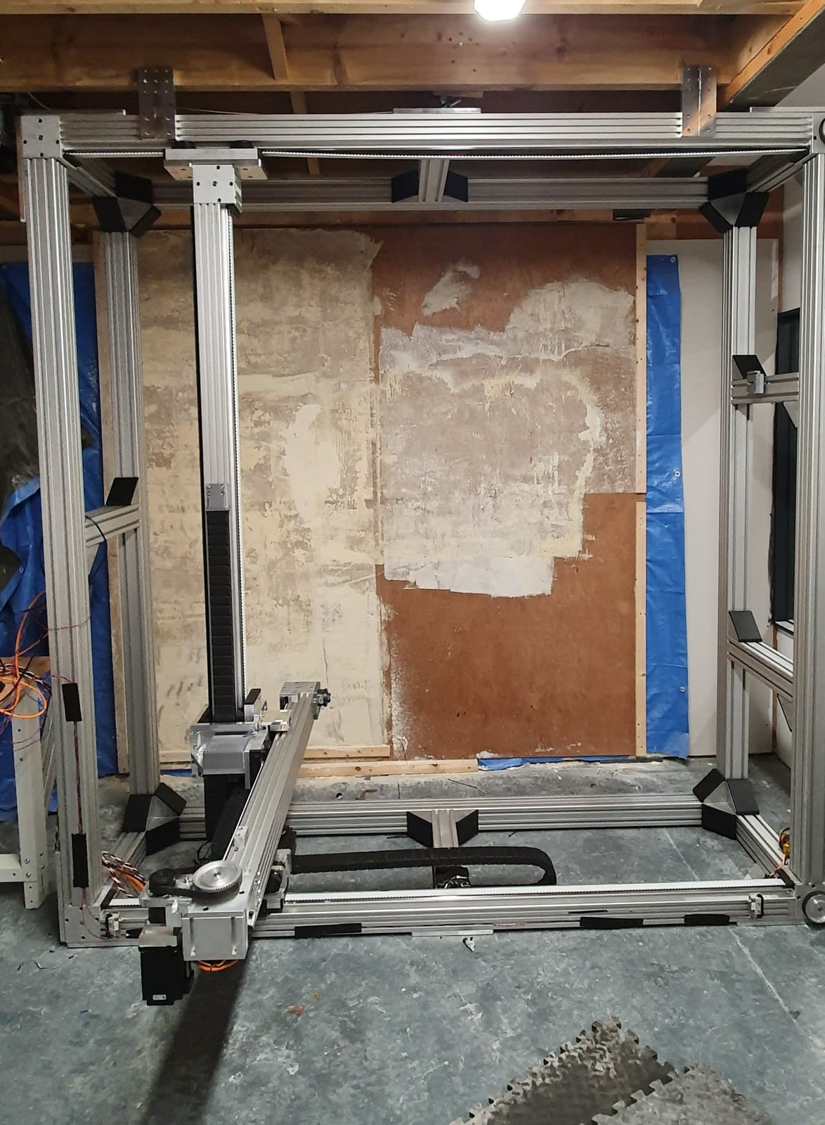 The 5-axis gantry prototype set up in front of a stripped test wall